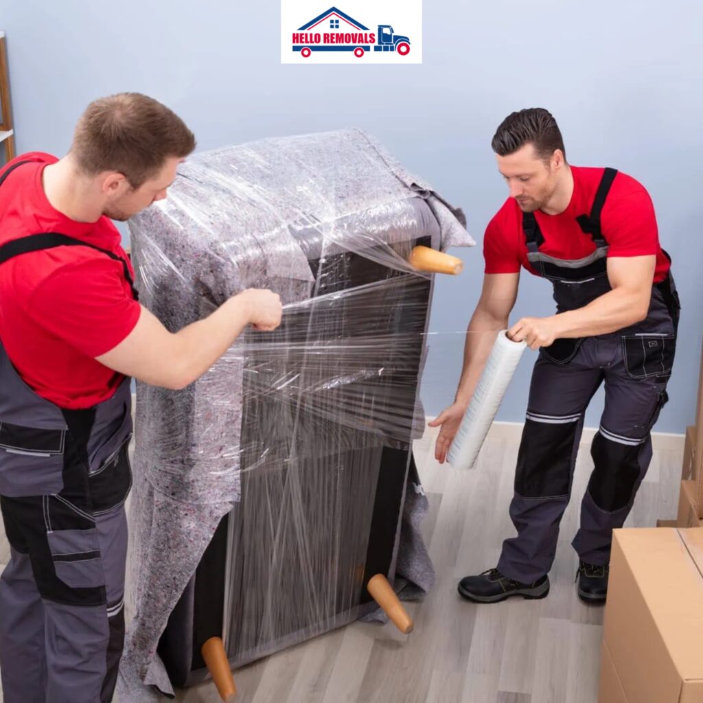 Movers wrapping furniture for transport – Hello Removals.