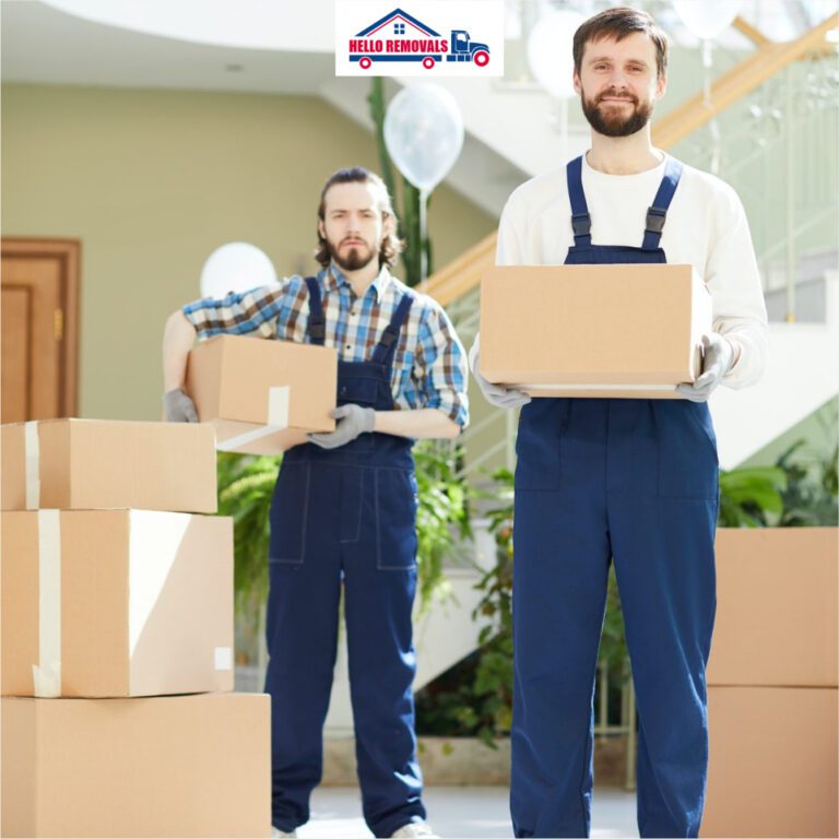Professional movers from Hello Removals carrying packed boxes during a home move.