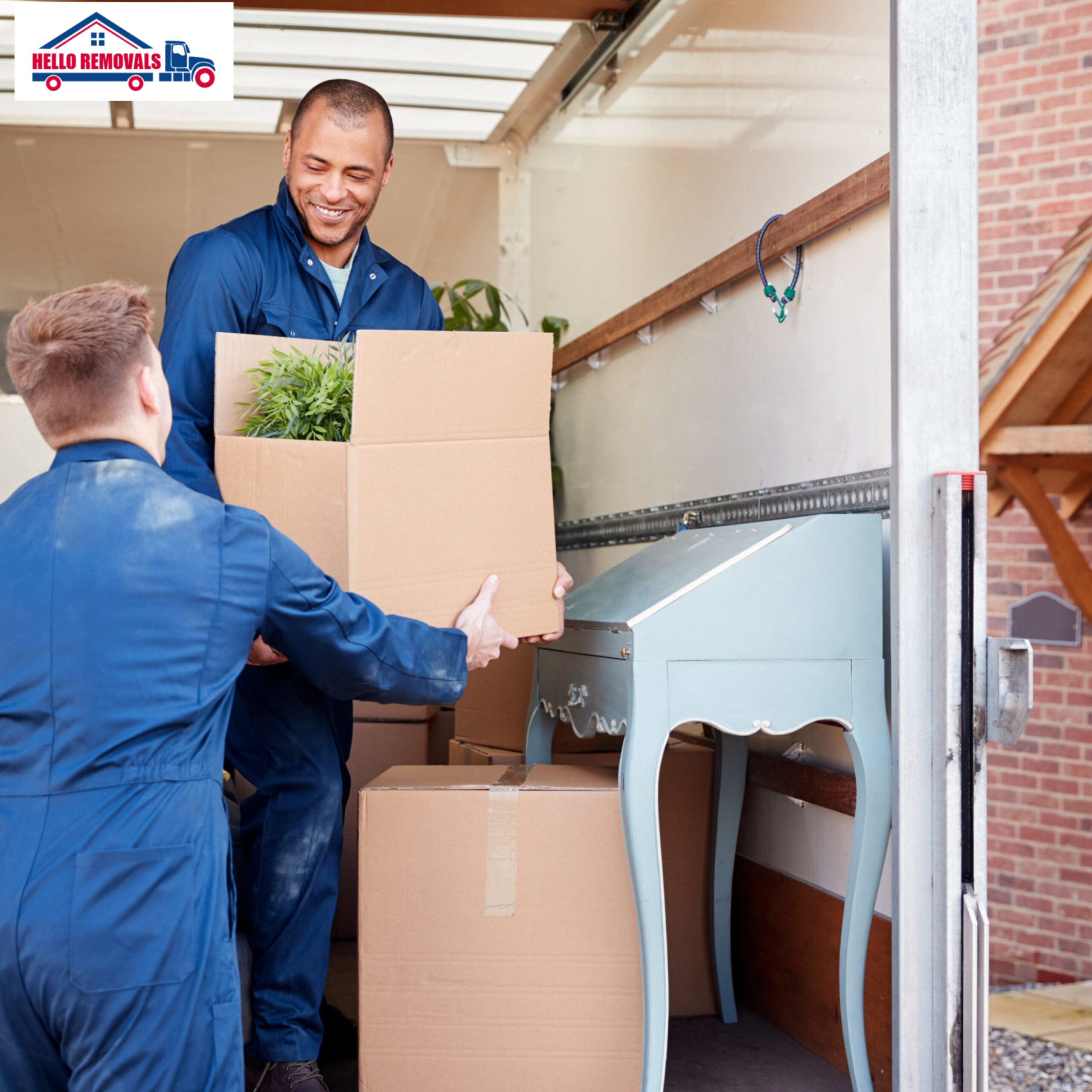 Professional movers loading packed boxes into a removal truck for home relocation